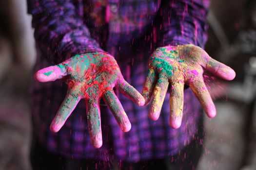 INDIA, Allahabad: A child bears vibrantly colored paints during Holi celebrations in Allahabad, India on March 24, 2016. Hindu devotees splatter each other with paint during Holi celebrations to mark the advent of spring. It is celebrated across the country and in many other countries in the region.
