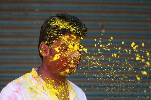 INDIA, Allahabad: A man is splattered with vibrantly colored paints during Holi celebrations in Allahabad, India on March 24, 2016. Hindu devotees splatter each other with paint during Holi celebrations to mark the advent of spring. It is celebrated across the country and in many other countries in the region.