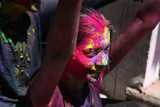 INDIA, Allahabad: A child wears vibrantly colored paints during Holi celebrations in Allahabad, India on March 24, 2016. Hindu devotees splatter each other with paint during Holi celebrations to mark the advent of spring. It is celebrated across the country and in many other countries in the region.