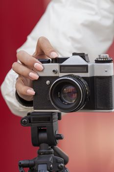 the girl in the hands of is holding the vintage camera