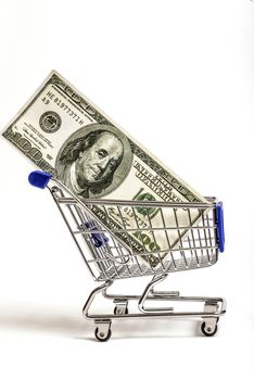 Hundred dollar bill in a shopping cart on white background