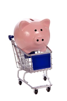 Pink piggy bank in little shopping cart.  Isolated on white.  Also, notice the blank sign for your copy on front of shopping cart.