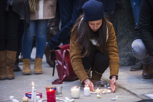 CANADA, Montreal: A woman lights candles at a vigil in Montreal, Canada on March 23, 2016 for the victims of the attacks in Brussels, Belgium that killed at least 30 people and injured hundreds of others the day before. Responsibility for the bombings at Zavetum airport and Molenbeek metro station was later taken by the Islamic State terror group.