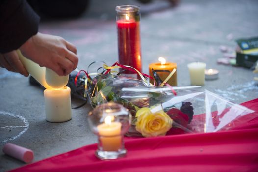 CANADA, Montreal: A woman lights candles at a vigil in Montreal, Canada on March 23, 2016 for the victims of the attacks in Brussels, Belgium that killed at least 30 people and injured hundreds of others the day before. Responsibility for the bombings at Zavetum airport and Molenbeek metro station was later taken by the Islamic State terror group.