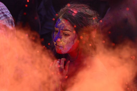 INDIA, Pushkar: A reveler looks through a mist of paint during the Hindu Holi celebrations in Pushkar, Rajasthan, India on March 24, 2016. Holi is the festival of colors that also marks the advent of spring. It is celebrated across the country and in many other countries in the region.