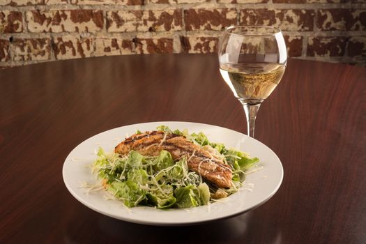 Grilled Chicken Cesar Salad with a glass of Chardonnay