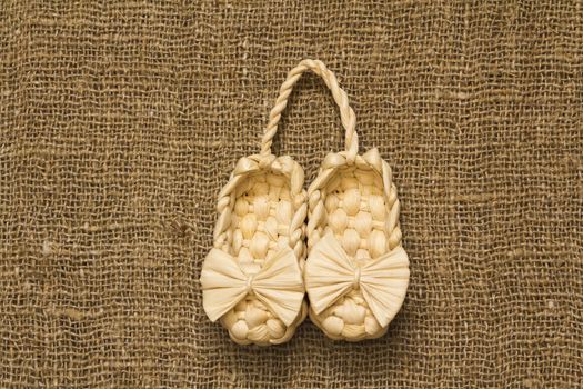 souvenir Old Russian sandals made of bark on a Brown background