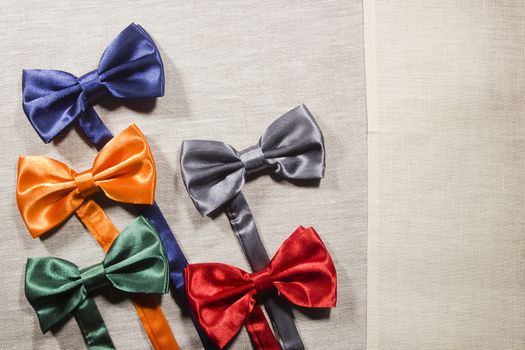 Set the bow tie in different colors for the celebration on a gray background