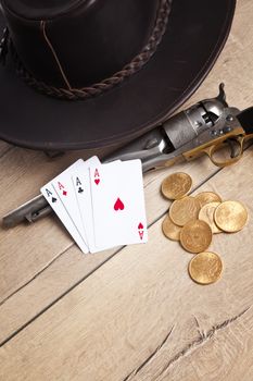 gambling and crime concept with gun, cards and golden coins