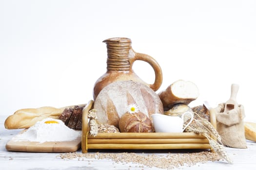 Freshly baked bread,honey and eggs on wooden vintage table