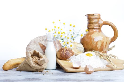 Freshly baked bread,honey and eggs on wooden vintage table