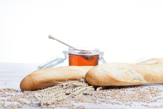 Freshly baked bread,honey and eggs on wooden vintage table