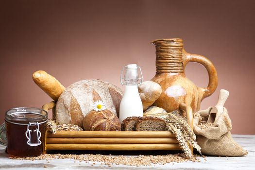 Freshly baked bread,honey and eggs on wooden vintage table