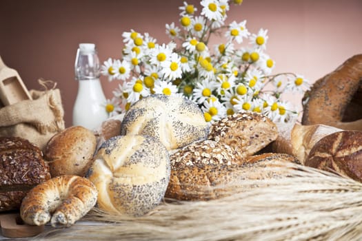 Freshly baked bread,honey and eggs on wooden vintage table