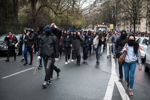 FRANCE, Paris: High-school students protest against alledged police violence on a student during a demonstration of youths against the French labour law reform, on March 25, 2016 in the 19th arrondissement of Paris.A video of a policeman punching a student went viral on social media on March 24, and an enquiry has been opened into the incident. Tens of thousands of students protesting labour reforms took to the streets across France on March 24, torching cars in Paris and clashing with riot police who responded with tear gas and made more than 30 arrests.
