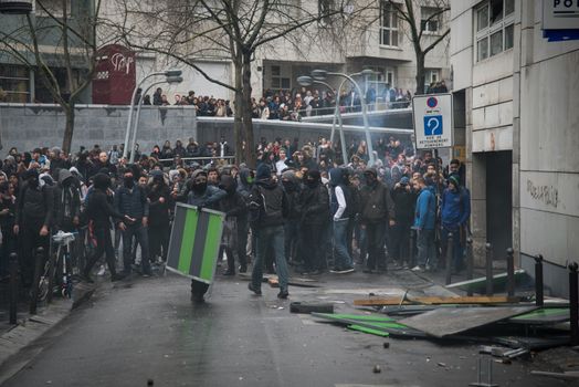 FRANCE, Paris: Young people throw projectiles against the police station of Paris 19th arrondissement, on March 25, 2016, in a sign of protest against alledged police violence on a student during a demonstration of youths against the French labour law reform.A video of a policeman punching a student went viral on social media on March 24, and an enquiry has been opened into the incident. Tens of thousands of students protesting labour reforms took to the streets across France on March 24, torching cars in Paris and clashing with riot police who responded with tear gas and made more than 30 arrests.