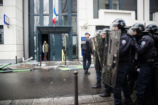 FRANCE, Paris: Policemen stand next a damaged police station, on March 25, 2016, after young people throw projectile against it, in a sign of protest against alledged police violence on a student during a demonstration of youths against the French labour law reform.A video of a policeman punching a student went viral on social media on March 24, and an enquiry has been opened into the incident. Tens of thousands of students protesting labour reforms took to the streets across France on March 24, torching cars in Paris and clashing with riot police who responded with tear gas and made more than 30 arrests.