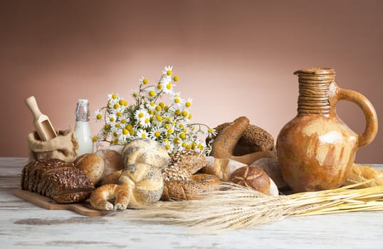 Freshly baked bread,honey and eggs on wooden vintage table