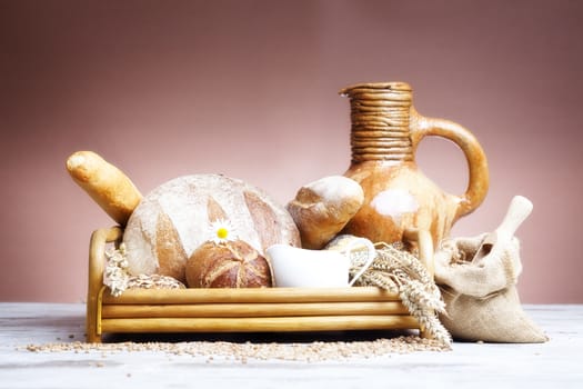 Freshly baked bread,honey and eggs on wooden vintage table