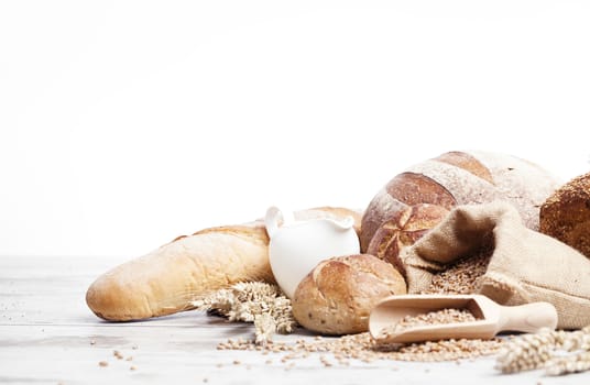 Freshly baked bread,honey and eggs on wooden vintage table