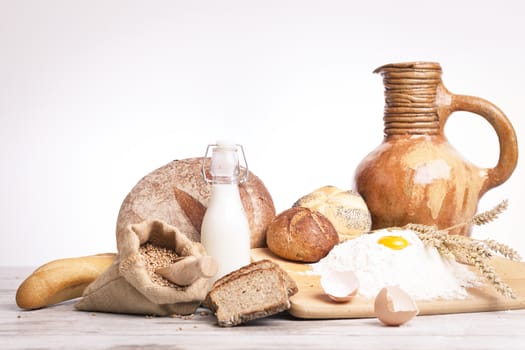 Freshly baked bread,honey and eggs on wooden vintage table