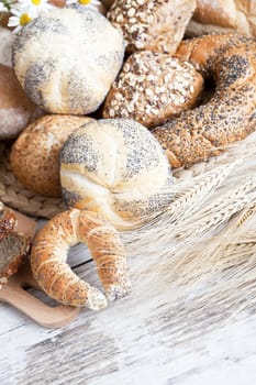 Freshly baked bread rolls, wheat ears and honey