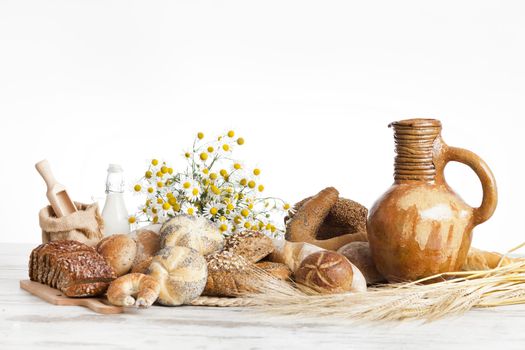 Freshly baked bread rolls, wheat ears and honey