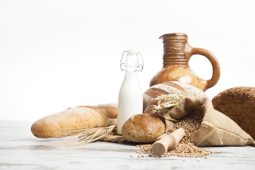 Freshly baked bread rolls, wheat ears and honey