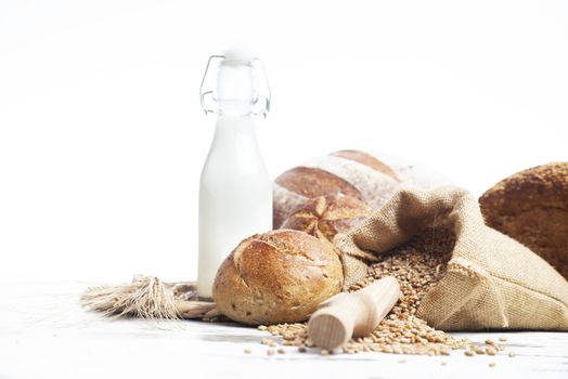 Freshly baked bread rolls, wheat ears and honey