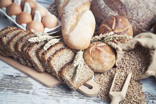 Freshly baked bread rolls, wheat ears and honey