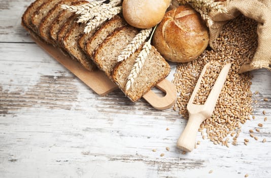 Freshly baked bread rolls, wheat ears and honey