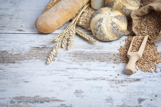 Freshly baked bread rolls, wheat ears and honey