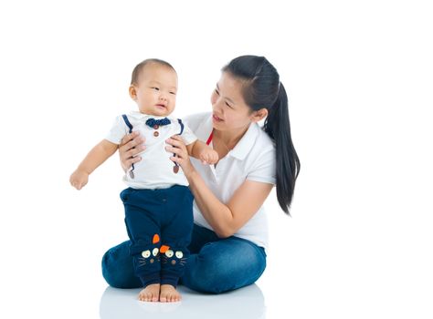 Asian mother playing with baby boy