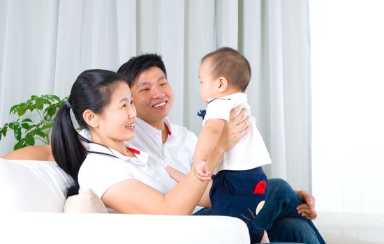 Asian family playing with baby