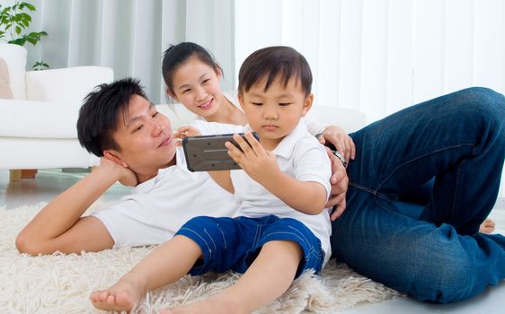 Asian family lying on the floor