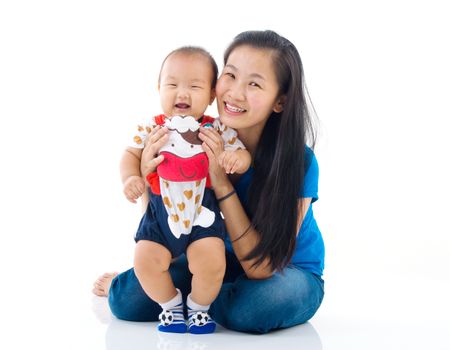 Asian mother playing with baby boy