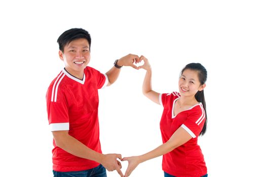Asian couple making heart shape with hands