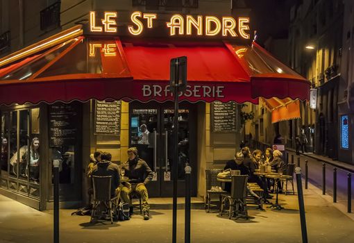 PARIS - MARCH 1: typical Paris cafe with people that enjoy dinner on March 1, 2014 in Paris, France