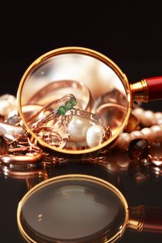 Set of various jewelry adornments through the magnifying glass