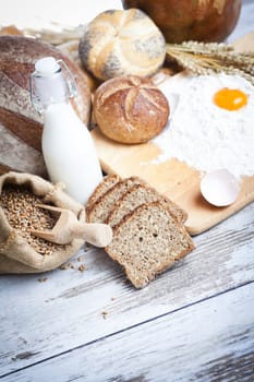 Freshly baked bread rolls, wheat ears and honey