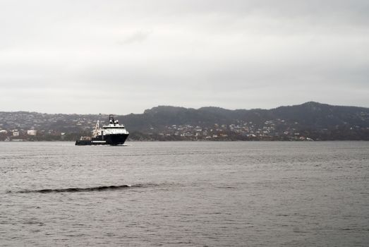 Cargo vessel is coming to port of Bergen, Norway