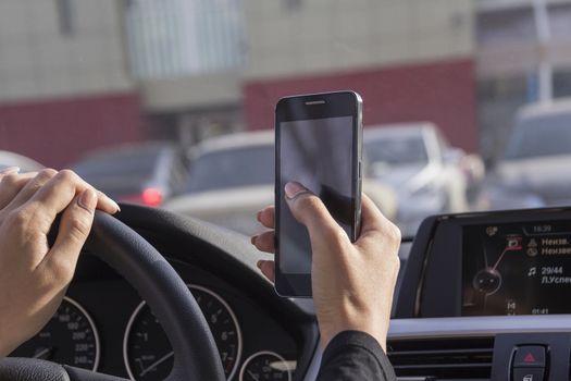 the girl picks up a text message on a mobile phone in the car