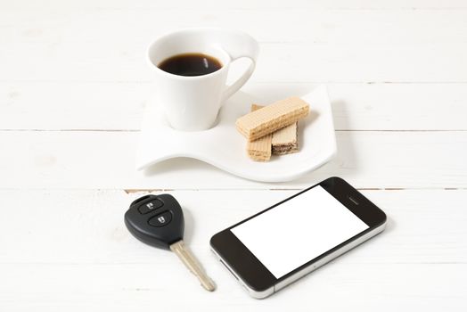 coffee cup with wafer,phone,car key on white wood background