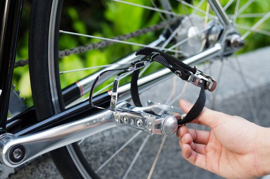 Close up of hand with bicycle pedal detail