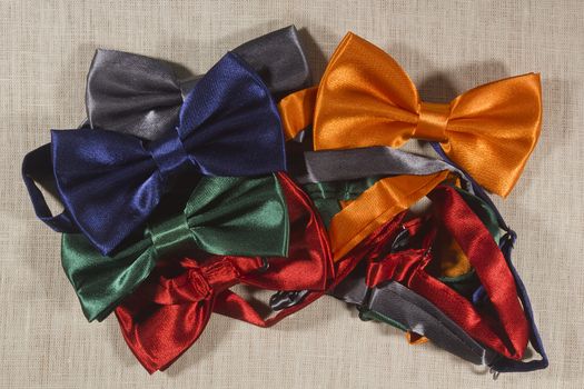 Set the bow tie in different colors for the celebration on a gray background