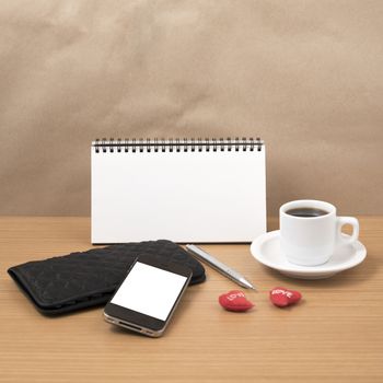 working table : coffee with phone,notepad,wallet and red heart on wood background