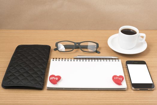 office desk : coffee with phone,notepad,eyeglasses,wallet,heart on wood background