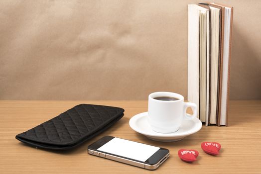 office desk : coffee with phone,heart,stack of book,wallet on wood background