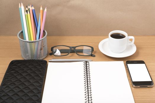 office desk : coffee with phone,notepad,eyeglasses,wallet,color pencil box on wood background