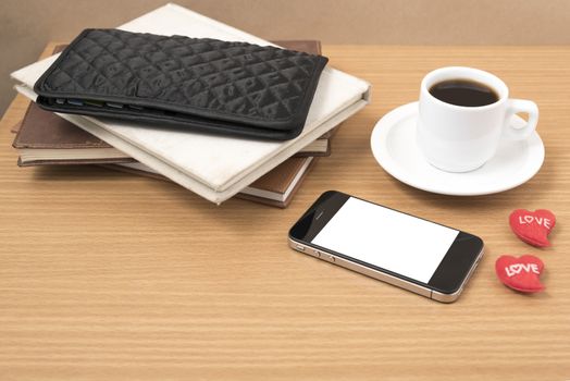 office desk : coffee with phone,heart,stack of book,wallet on wood background